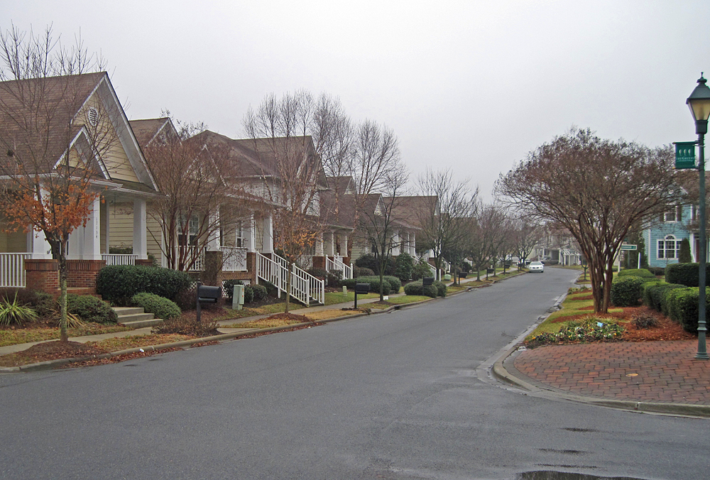Homes facing a park in Birkdale Village, Huntersville Front porches and a tree-lined residential street beside park space in Birkdale Village, Huntersville